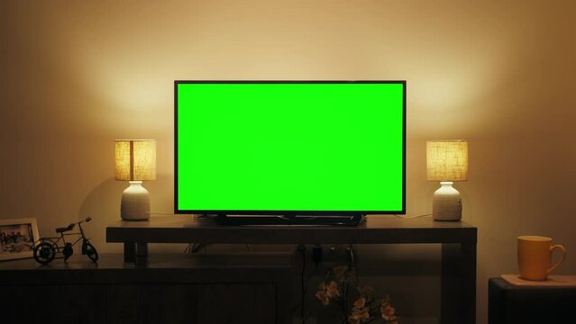 LcD smart TV screen with a blank green background in the living room. Chroma key screen for advertising.