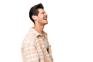 Young handsome caucasian man over isolated background laughing in lateral position