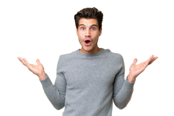 Young handsome caucasian man over isolated background with shocked facial expression