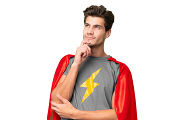 Young handsome caucasian man over isolated background in superhero costume and thinking © luismolinero