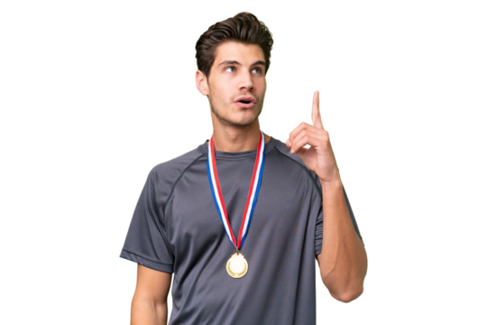 Young caucasian man with medals over isolated background thinking an idea pointing the finger up