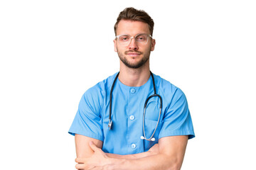 Young nurse man over isolated chroma key background keeping the arms crossed in frontal position