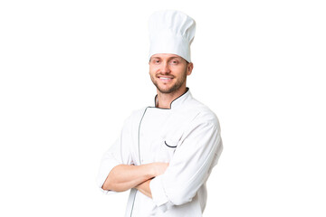 Young caucasian chef over isolated chroma key background with arms crossed and looking forward