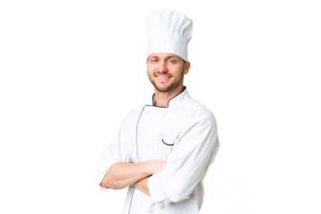 Young caucasian chef over isolated chroma key background with arms crossed and looking forward