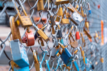 Love locks on a railing. A close-up shot of love padlocks on a fence which signify everlasting love...