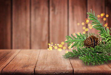 Christmas Tree Branches and Pine Cone on Old Wooden Table