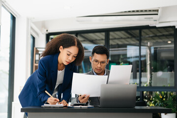 Furious two Asian businesspeople arguing strongly after making a mistake at work in office.