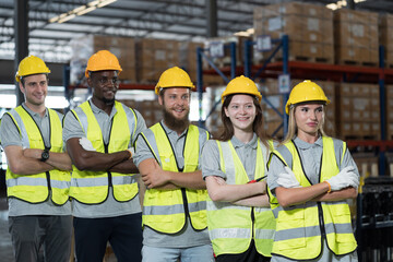 Warehouse and teamwork concept. Group of warehouse worker standing with crossed arms at warehouse