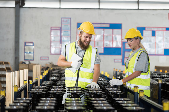 Warehouse and manufacturing concept. Male and female warehouse worker working and checking spare parts at warehouse