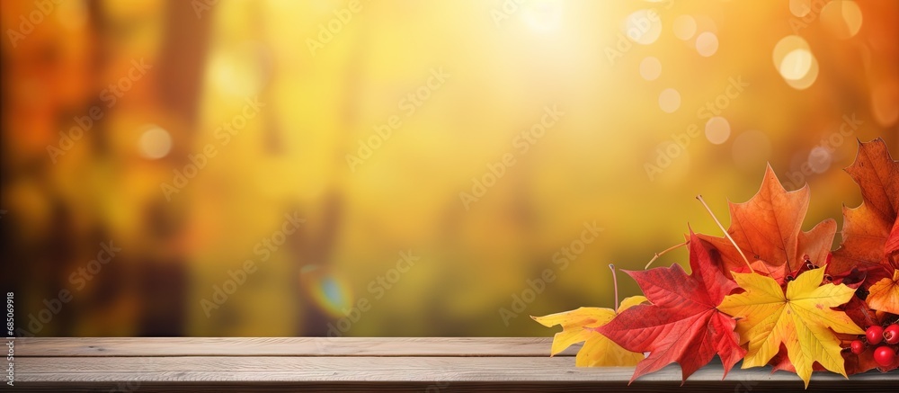 Poster Fall themed table with red and yellow leaves amid forest backdrop copy space image