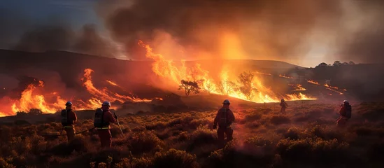 Foto op Canvas Firefighters handling a massive grassfire in Welsh upland moors copy space image © vxnaghiyev