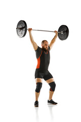Athletic, muscular, strong man training, lifting heavy barbell, weights against white background