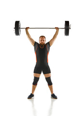 Fototapeta premium Bearded strong man, athlete training, lifting heavy weights, barbell against white background. Muscular strong body