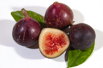 dark purple figs and a beautiful piece decorated with green lime leaves