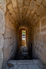 Stone block hallway with vaulted ceiling and granite stairs to the Moorish citadel of Merida....