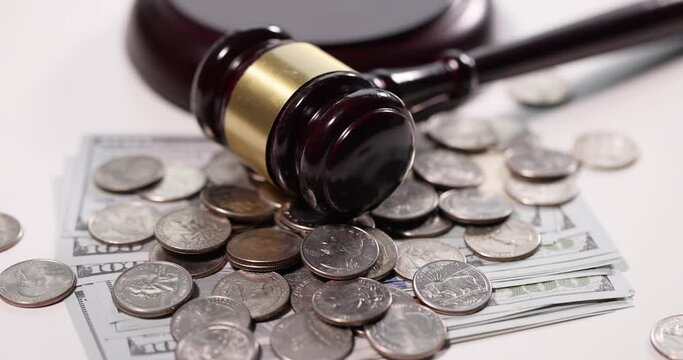 Judge gavel with cash and coins on table. Tax evasion concept