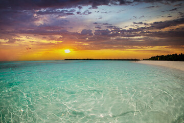 Maldives (Maldive) island beach. turquoise colored sea, tropical landscape, white sand with palm trees.  amazing nature. Sunset
