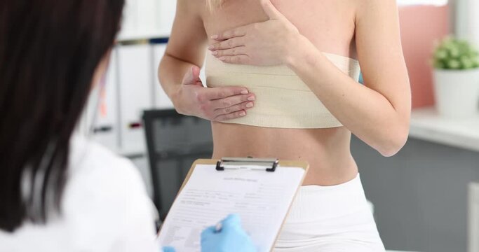 Mammologist conducts medical examination of patient breast. Lump and pain in chest concept