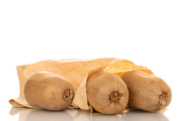 Three ripe sweet kiwis in a paper bag, macro, isolated on white background.