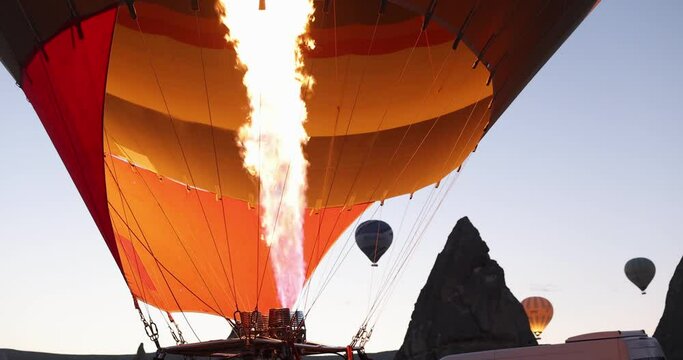 Movements of strong flame rising and inflating balloon. Preparing a hot air balloon for flight concept