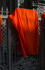 Orange Buddhist monks clothing hanging down in the pagoda