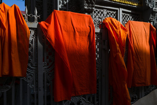 Orange Buddhist monks clothing hanging down in the pagoda