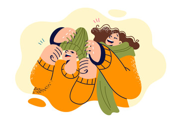 Laughing children don winter hats and scarves as head out for sunday walk or trip to ski resort