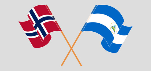 Crossed and waving flags of Norway and Nicaragua