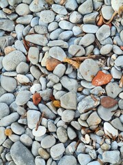 evocative texture image of stones of various shapes on a beach in Italy