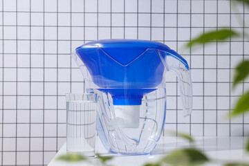 A water filter with a glass on a light background