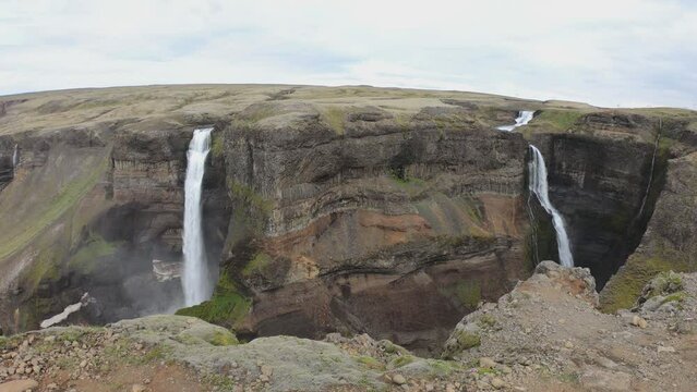 SLOW MOTION SHOT - Haifoss and its neighbour Granni. H&aacute;ifoss, or the 'High Waterfall', is a waterfall in Foss&aacute;rdalur valley, innermost of &THORN;j&oacute;rs&aacute;rdalur valley, in South Iceland.