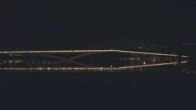Coimbra bridge illuminated at night.