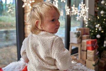 Toddler in house decorated for Christmas