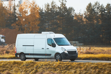 A white van on the road, shipping cargo and packages from the warehouse to the customers, showing...