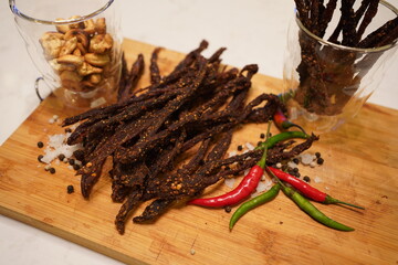 Strips of dry beef chili jerky with salt and chilies
