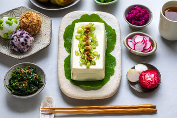 Japanese lunch with silken tofu, onigiri, spinach gomae, miso leeks ad pickled vegetables