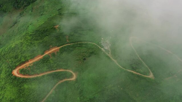 Drone of mountains, nature and road or highway for travel, adventure and holiday or eco tourism background. Top or aerial view of green landscape, clouds or infrastructure in Vietnam, Ma Pi Leng Pass