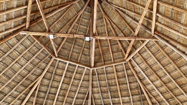 the interior of a thatched roof with a router and modem attached
