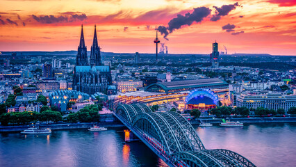 Cologne Koln Germany during sunset, Cologne bridge with the cathedral. beautiful sunset at the Rhine River with a view at the Hohenzollern bridge and the skyline of Cologne - obrazy, fototapety, plakaty