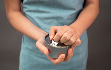 Opening a tin can with preserved food, box with tuna fish, processed ingredients, feeding a pet
