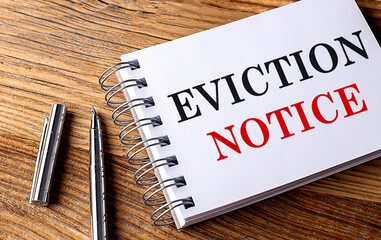 EVICTION NOTICE text on notebook with pen on wooden background