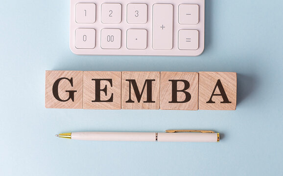 GEMBA on wooden cubes with pen and calculator, financial concept