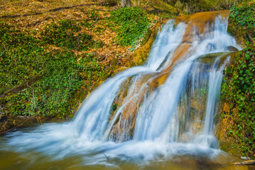 Fototapeta na wymiar small waterfall on the mountain river