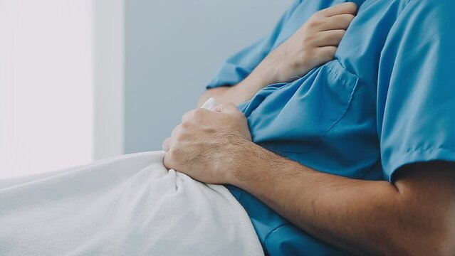 Sick Caucasian patient having stomach pain with Asian doctor taking care in hospital. Sick patient will pay for medical fee by healthcare insurance. doctor and patient & healthcare insurance concept.