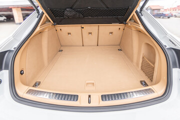Car interior luxury. Beige comfortable seats, steering wheel, dashboard, climate control,...