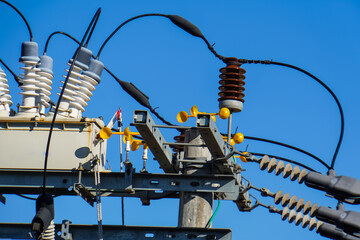 close up of electric power transmission line during the day. High voltage switchgear and power...