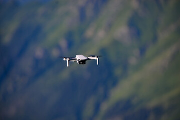 Fototapeta na wymiar Professional cinema drone in flight. Aircraft in the mountain at high altitude