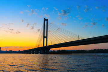 Modern Cable-Stayed Bridge over Water at Sunset