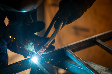 worker with protective mask welding metal