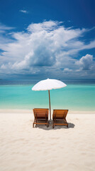 Beach chairs and umbrella on tropical beach with turquoise water.